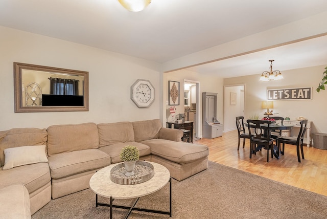 living room with an inviting chandelier and light hardwood / wood-style floors