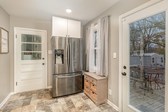 kitchen with stainless steel fridge with ice dispenser and white cabinets