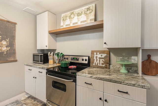 kitchen with appliances with stainless steel finishes and stone countertops