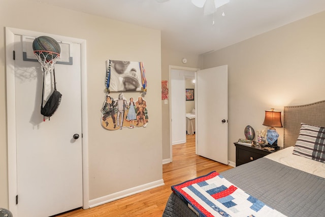 bedroom with light hardwood / wood-style floors and ceiling fan