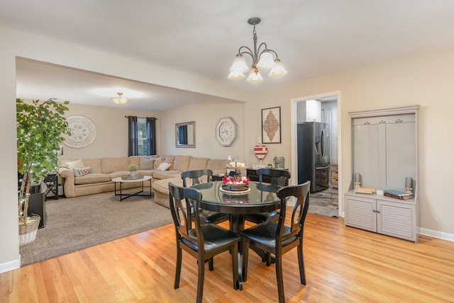 dining area featuring a chandelier and light hardwood / wood-style flooring