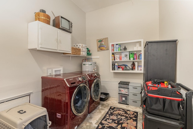 laundry area with cabinets, electric water heater, and washer and clothes dryer