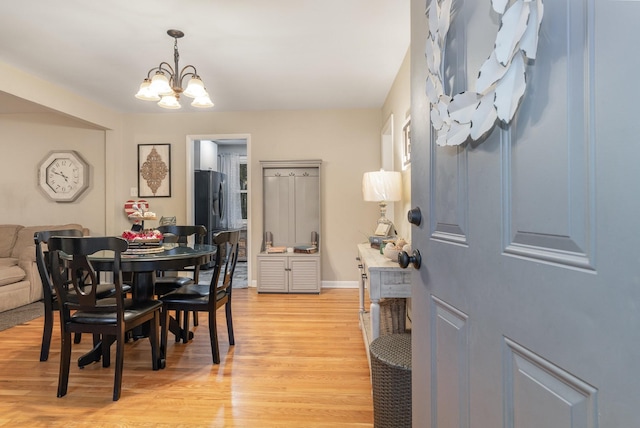 dining area with an inviting chandelier and light wood-type flooring