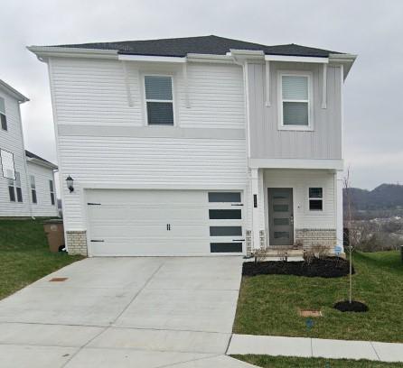 view of front of home with a garage and a front yard