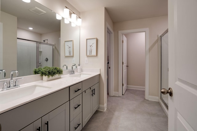 bathroom with tile patterned flooring, vanity, and an enclosed shower