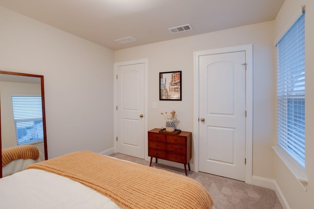 bedroom featuring light carpet