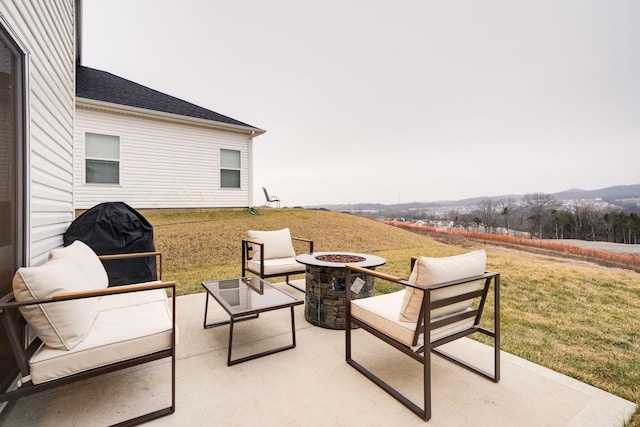 view of patio with a grill and an outdoor living space with a fire pit