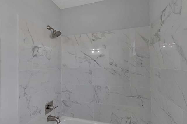 interior details with tiled shower / bath combo