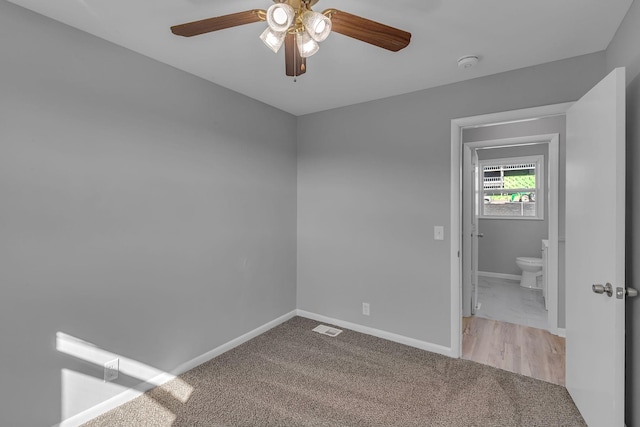 spare room with light colored carpet and ceiling fan