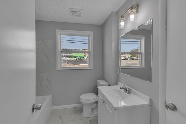 bathroom with vanity, a textured ceiling, and toilet