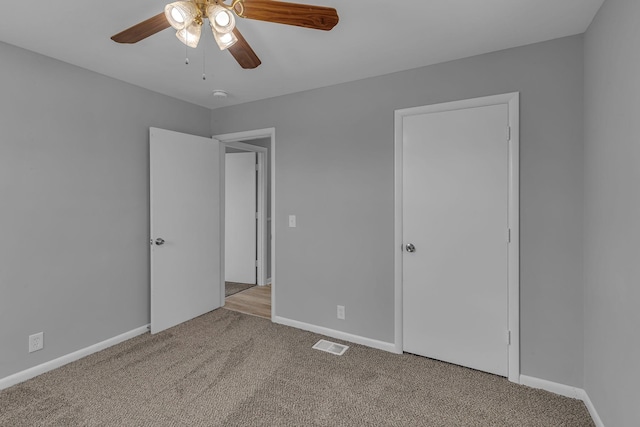 unfurnished bedroom with carpet and ceiling fan