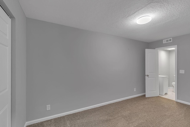 unfurnished bedroom featuring carpet floors and a textured ceiling