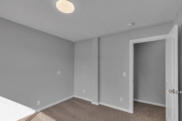 unfurnished bedroom with carpet floors and a textured ceiling