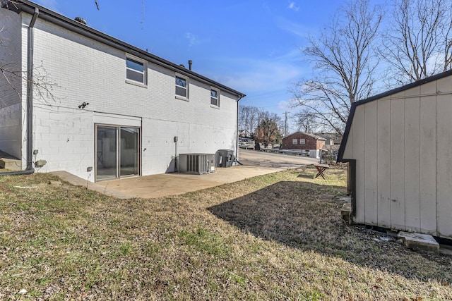 rear view of house with cooling unit, a yard, and a patio area