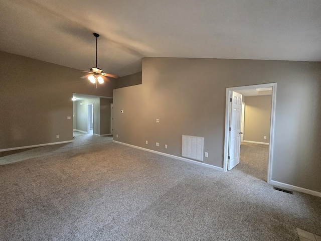 carpeted spare room featuring lofted ceiling and ceiling fan