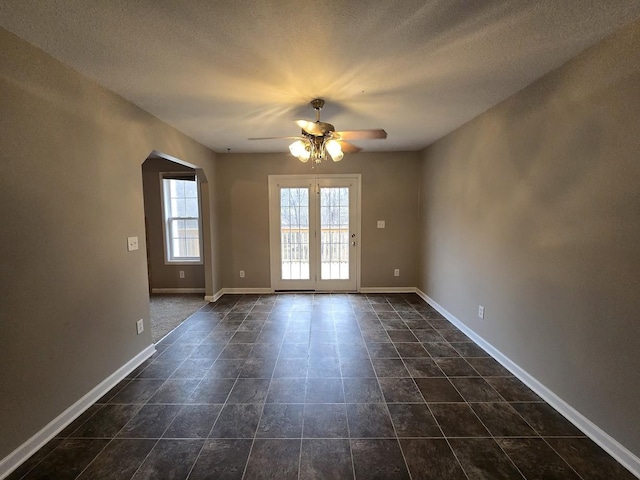 unfurnished room featuring a textured ceiling and ceiling fan