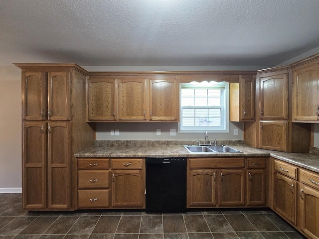 kitchen featuring black dishwasher, sink, and a textured ceiling