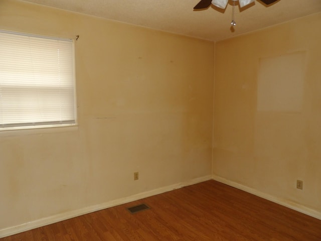 spare room with ceiling fan and wood-type flooring