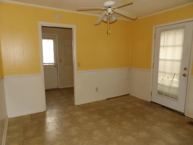 unfurnished room with ceiling fan and ornamental molding