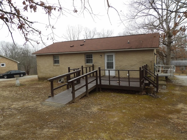 back of house with a wooden deck