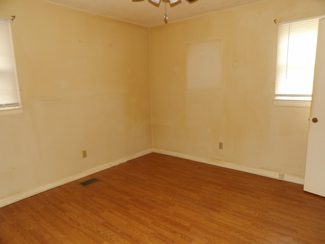 spare room with wood-type flooring and ceiling fan