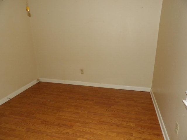 unfurnished room with wood-type flooring