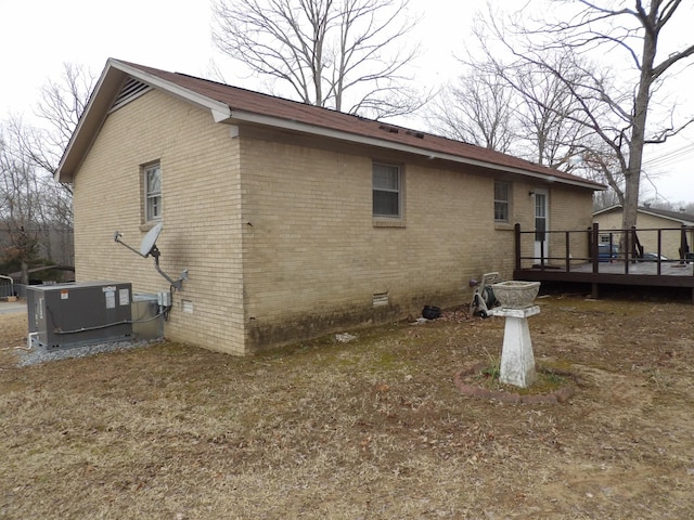 back of house with a wooden deck and central air condition unit