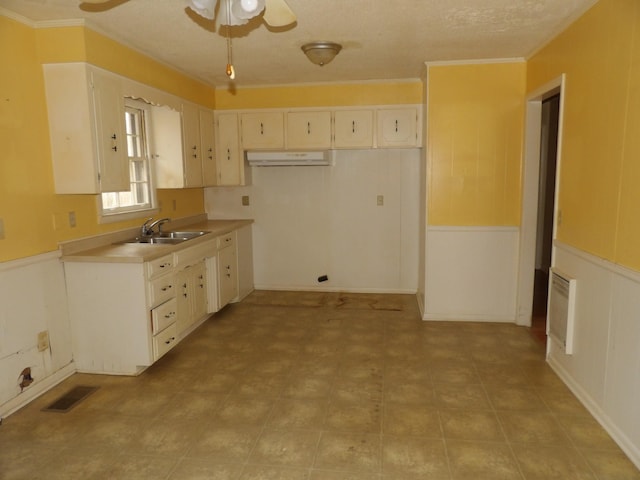 kitchen featuring crown molding, sink, ceiling fan, and a textured ceiling