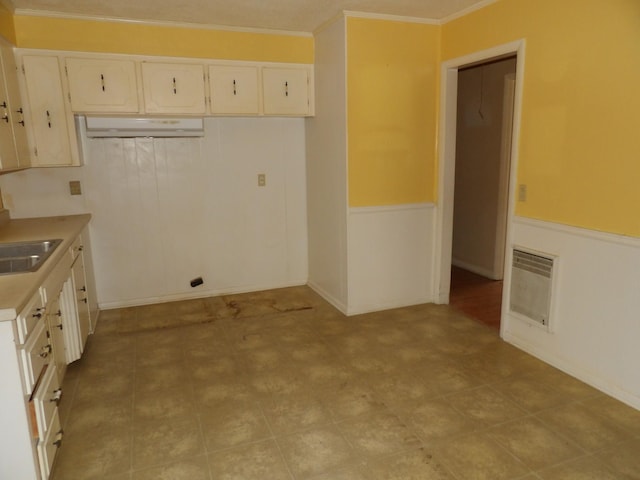 kitchen with a wall mounted air conditioner, ornamental molding, and sink