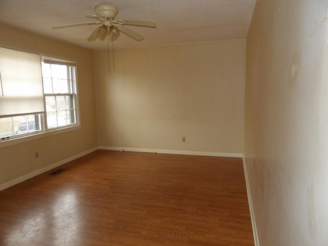 unfurnished room with ceiling fan and wood-type flooring