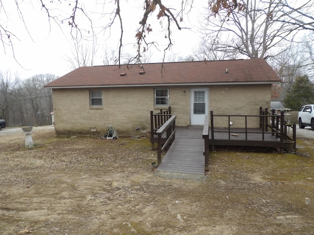 back of house with a deck