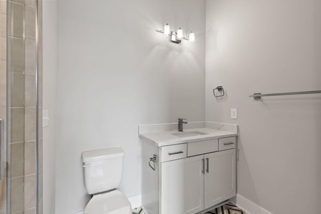 bathroom featuring vanity, a shower, and toilet