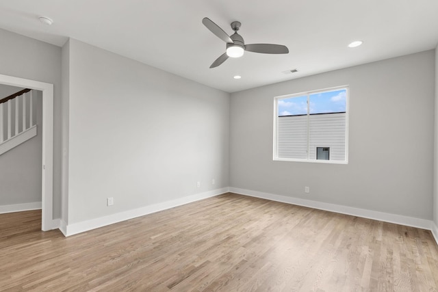 spare room with ceiling fan and light wood-type flooring