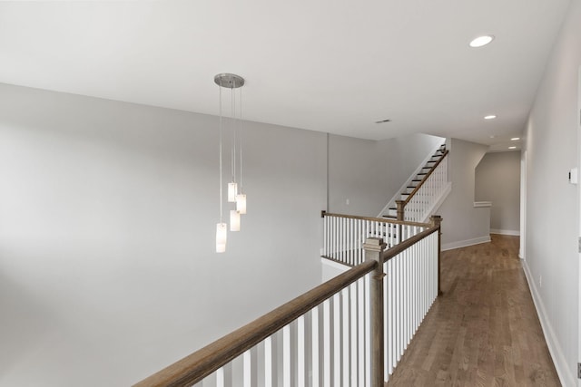 corridor with hardwood / wood-style flooring