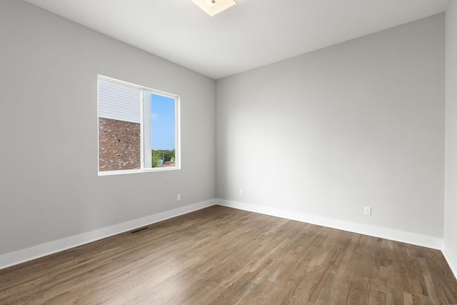 unfurnished room with hardwood / wood-style floors