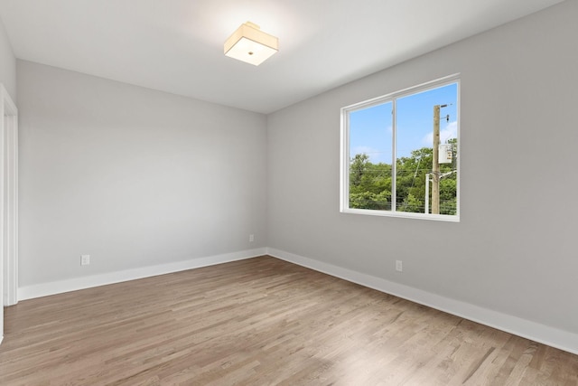 unfurnished room with light wood-type flooring