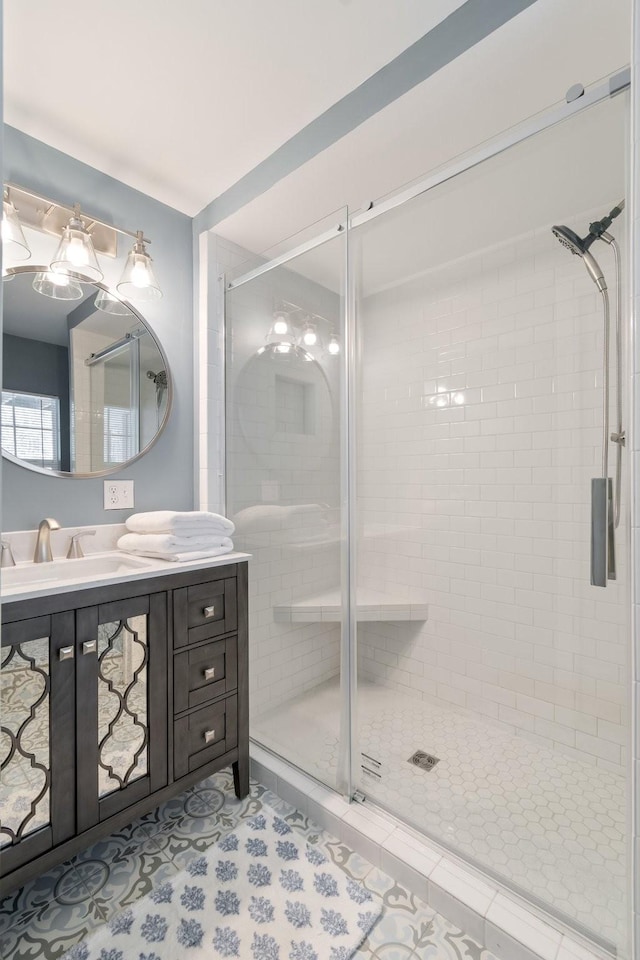 bathroom featuring tile patterned flooring, vanity, and an enclosed shower