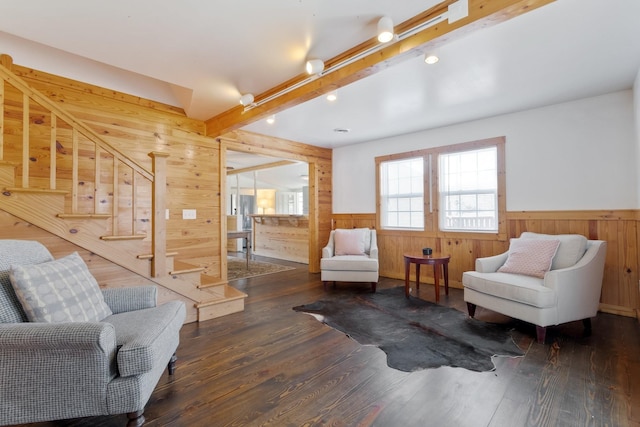 living room with beam ceiling and dark hardwood / wood-style flooring