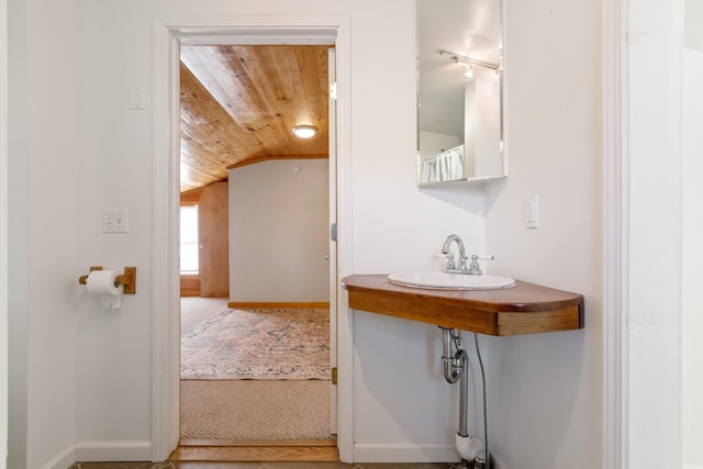 bathroom with sink, vaulted ceiling, and wooden ceiling