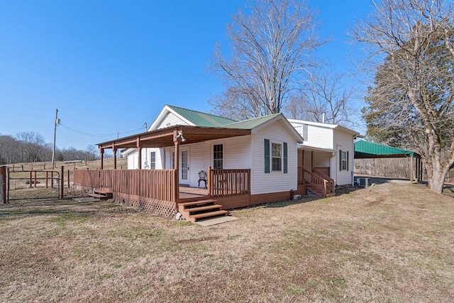 back of property featuring a lawn and central air condition unit