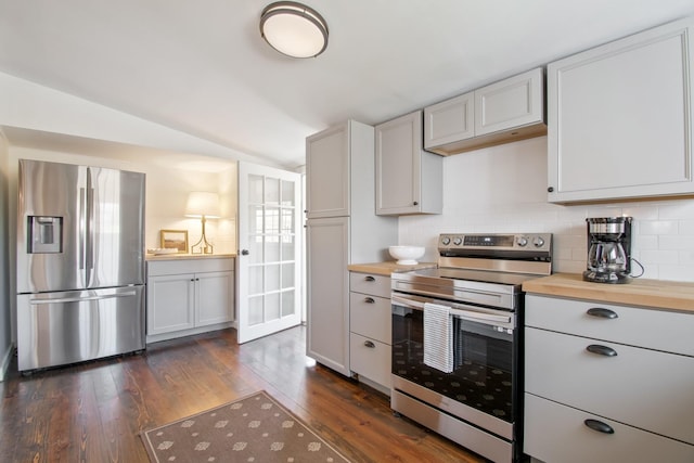 kitchen with dark hardwood / wood-style flooring, appliances with stainless steel finishes, white cabinets, and butcher block countertops