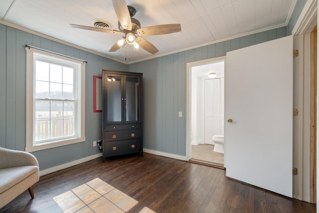 unfurnished room with crown molding, dark hardwood / wood-style floors, and ceiling fan