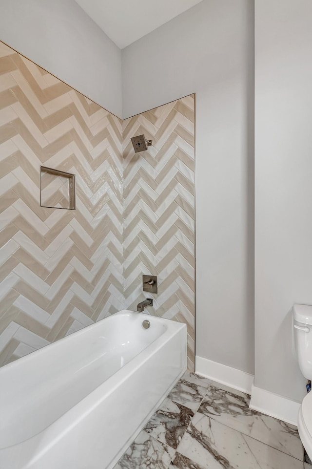 bathroom featuring washtub / shower combination and toilet