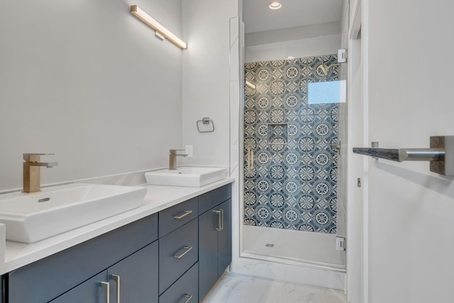 bathroom featuring tiled shower and vanity