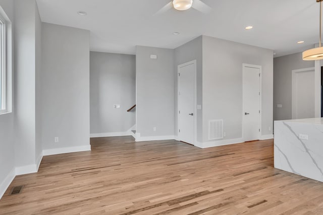 interior space with ceiling fan and light hardwood / wood-style floors