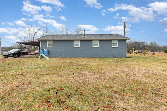 back of house featuring a yard and a carport