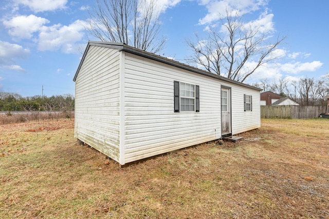 view of property exterior featuring a yard and an outdoor structure