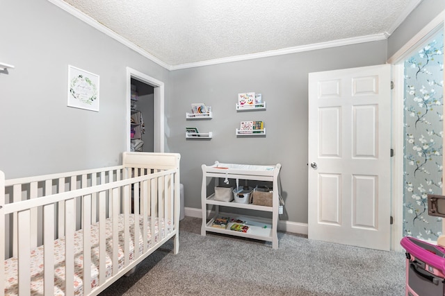 carpeted bedroom featuring a nursery area, ornamental molding, and a textured ceiling