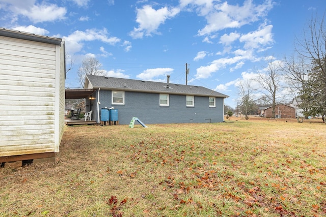 back of house with a lawn