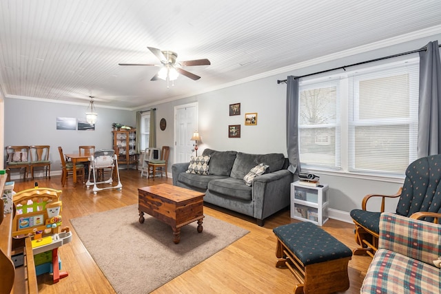 living room with crown molding, ceiling fan, and light hardwood / wood-style flooring